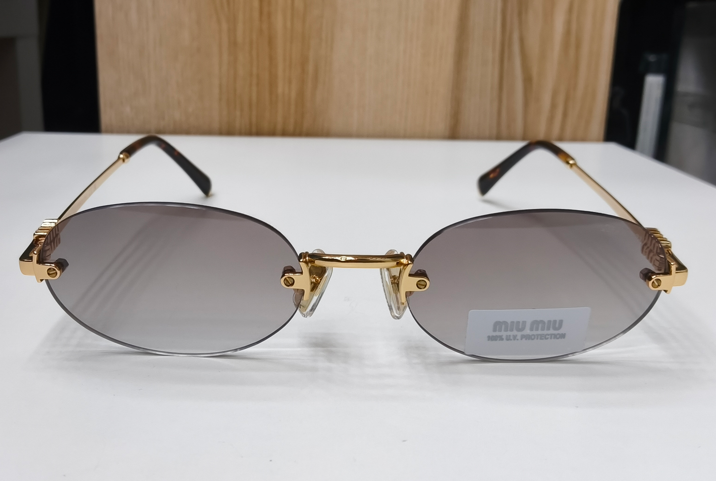 Miu Miu MU A54S rimless oval sunglasses